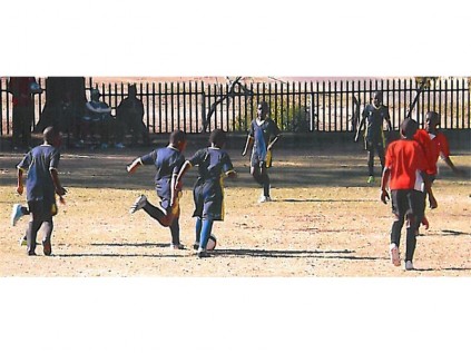 Enjoying a game of soccer out on the field.