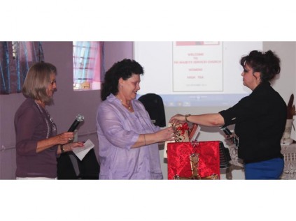 A GIFT: Pastor Hester (left) and Ursula (right) say thank you to Sandra for attending the function as the guest speaker and hand her a gift.