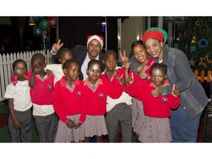 JOYFUL MOMENTS: Children from OR Tambo Primary School with Airport Assistant General Manager Kris Reddy and General Manager Bongiwe.