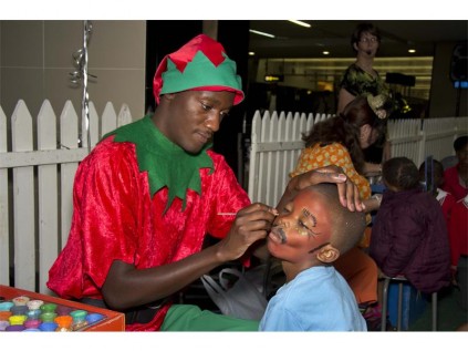 FUN-FILLED: A paint artist preparing the kids with funny painted faces at the third annual SED Children’s Party.