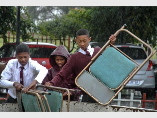 HELPING HAND: Learners help offload their new chairs.