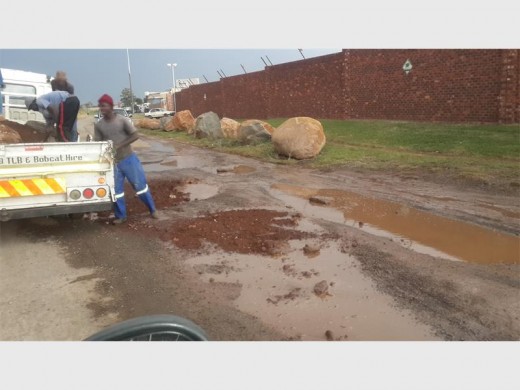 BUSINESS OWNERS TAKE THE LEAD: This Alrode business owner filled holes with soil and gravel.
