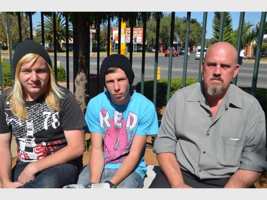 ATTACKED: Martienus and Mario Schwab, Marionette's sons, and Darrel Badenhorst in the parking lot of the Union hospital after they had visited her.