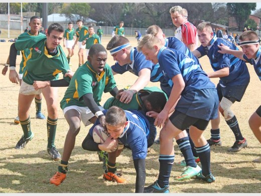 IT’S MINE: Alberton High School’s Dylan Palk holds onto the rugby ball with all his might as Hoërskool Carletonville players take him to the ground.