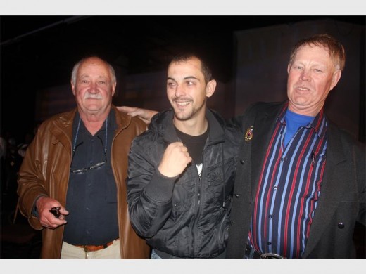 CONGRATULATIONS FOR CHAMP: Members of the East Rand Veterans Boxing Association (ERVBA) were on hand to congratulate Grant Fourie, the new SA champ, just after he lifted the SA junior welterweight title. From left Willie Stols, champion Grant Fourie and Allan Lundsberg.