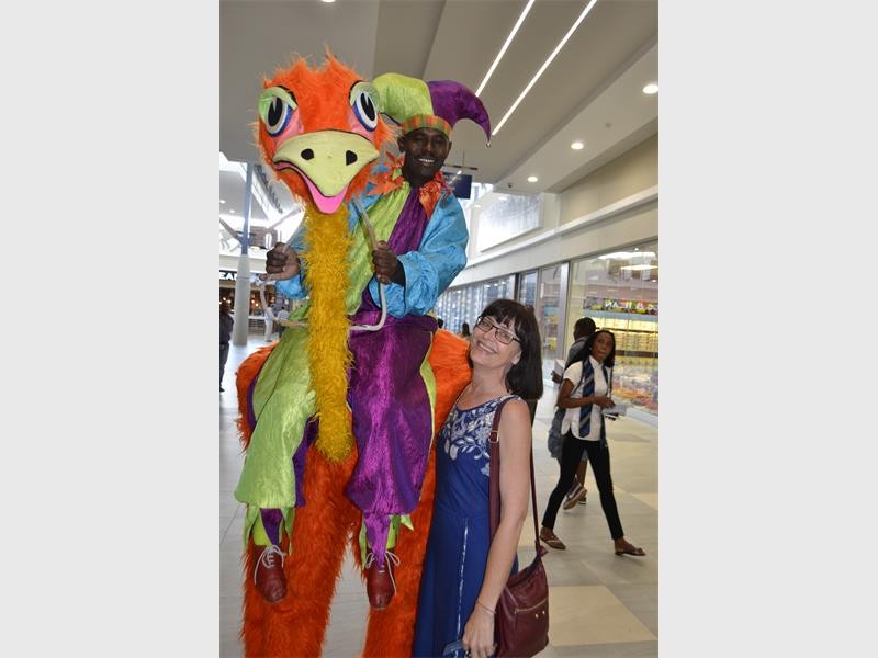 INSTORE ENTERTAINMENT: Alberton Record editor, Carina van der Walt, received a hug from the centre’s ostrich.