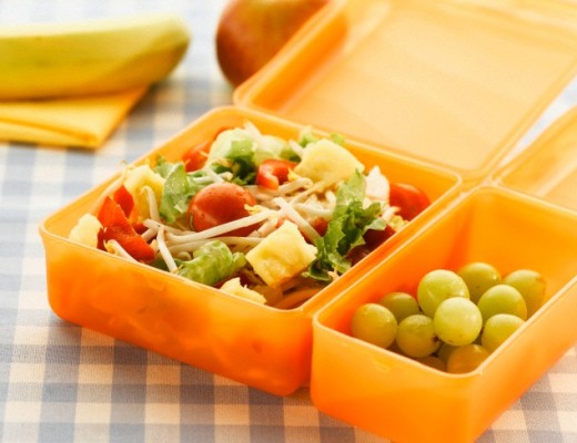 Lunch box with salad and grapes