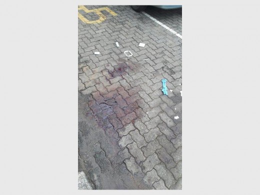 BLOODY PAVEMENT: The scene outside where the suspect was apprehended.