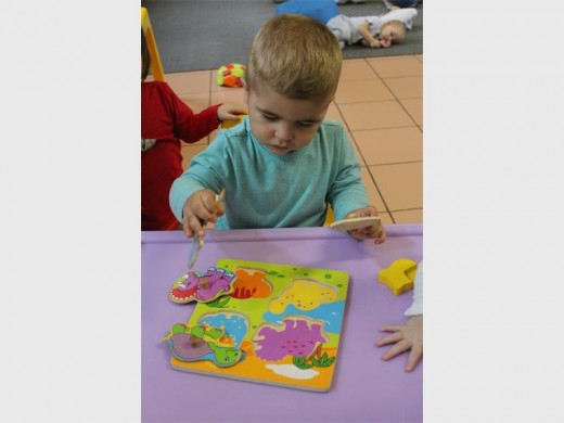 FUN: Joshua Chapman loves building his dinosaur puzzle.